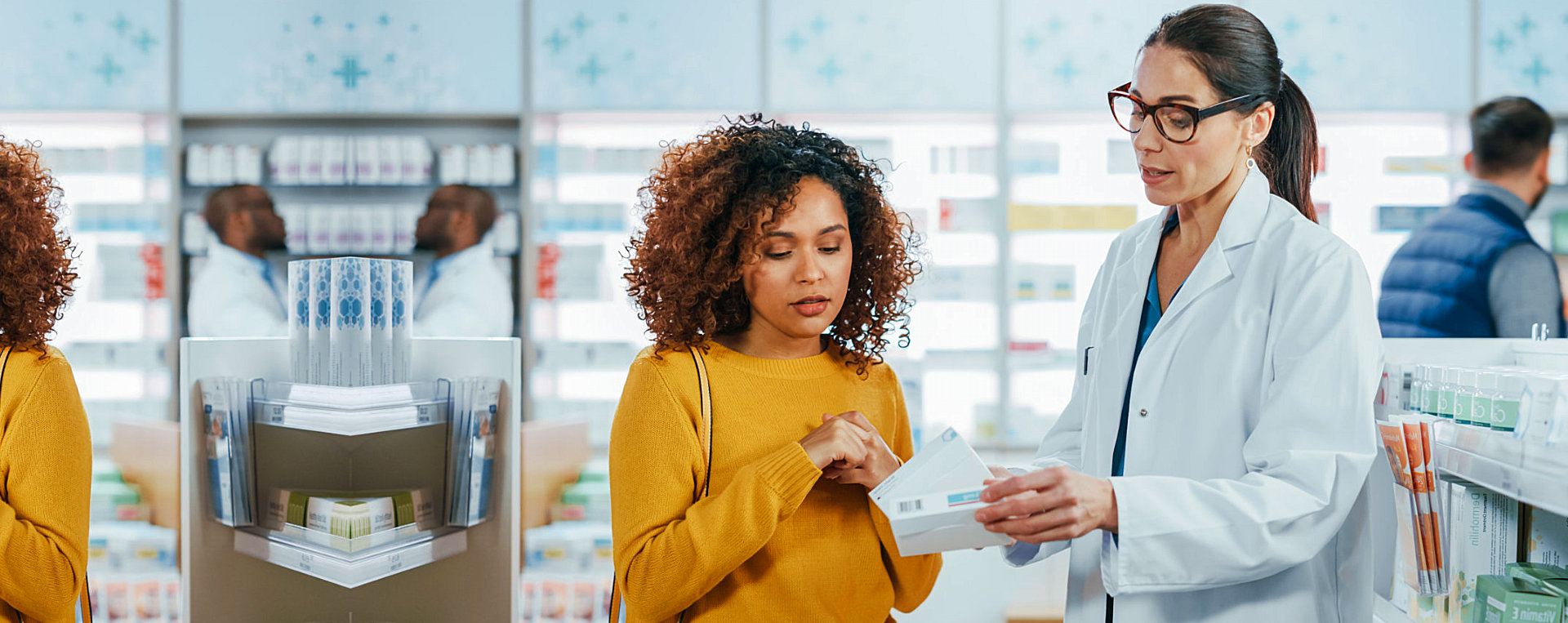 Pharmacist giving prescription to a young woman